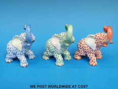 Three Herend elephants, fishnet design with trunks raised, in blue,