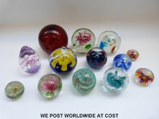 Thirteen various glass paperweights