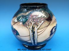 A Moorcroft pedestal limited edition vase (165/400) decorated with stylised trees and signed by