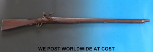Brown Bess type hammer action flintlock gun with brass butt plate and trigger guard and 42 inch