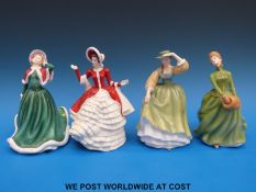 Four Royal Doulton figures comprising two different versions of Christmas Day, Grace,