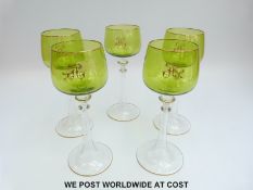 A set of ten hock glasses with green bowls monogrammed with the letter 'H' and gilt rims raised on