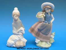 Two Lladro child figures with flowers and a lamb (16cm tall)
