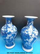 A pair of 19thC Chinese blue and white vases of bulbous form with waisted necks decorated with