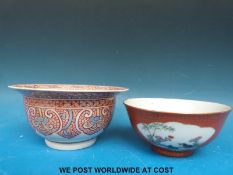 Chinese bowl decorated with two cartouche scenes of birds and flowers on an orange ground with gilt