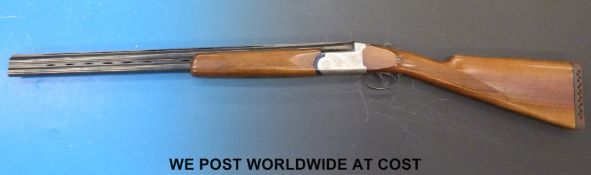 Lincoln 12 bore over and under shotgun with all over floral engraving, double trigger,