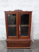 A glazed mahogany cabinet with two drawers under (W53 x D27 x H78cm)