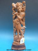 An Indian sandalwood carved figure of Krishna (30cm tall)