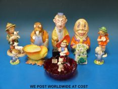 A collection of ceramic figures including Goebel Hummels, Wade 'Blynken', Beswick cat,