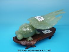 A hardstone/ jadeite figure of a guppy fish on stand