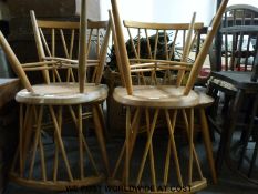 A set of four Ercol light elm stick back dining chairs