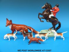 A Beswick hunting group to include rearing huntsman, three hounds,