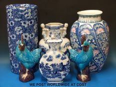 A collection of decorative blue & white vases, an umbrella stand, ceramic cockerels etc.