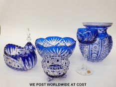 Six pieces of blue flash overlaid cut glassware comprising three bowls, bell,