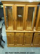 A pine display cabinet or dresser with glazed upper section,
