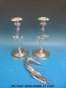 A pair of chrome Art Deco style figural candlesticks and a car mascot