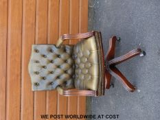 A leather swivel Chesterfield type armchair/office chair