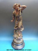 An early 20thC spelter figure of a Dutch girl on turned base (height 66cm)