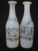A pair of Richardsons opaline glass spirit decanters of slender farm decorated in enamel with the