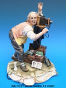 A signed Capodimonte figure of a photographer