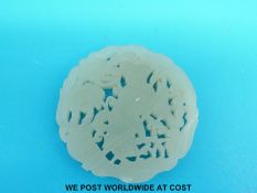 A Chinese jadeite carved disc depicting a figure