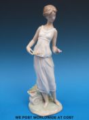 A Lladro figure of a girl with basket of flowers (26cm tall)