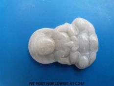 A carved Chinese pendant depicting Guanyin