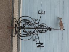 A Georgian wrought iron weather vane with copper fish indicator to top (height 122cm approx)