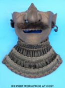 A Japanese Edo period Mempo with black cords.