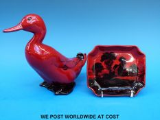 A Royal Doulton flambé pin dish signed Noke and a flambe duck (15cm tall)