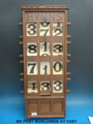 An oak church Hymn sign with revolving fabric numbers and a pokerwork elm sign 'Thy God Hath