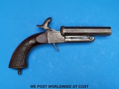 A hammer action pin fire percussion pistol with chequered grips and locks,