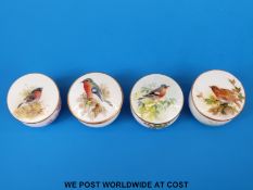 Four Royal Worcester miniature pill boxes, all hand decorated with birds and with puce marks,