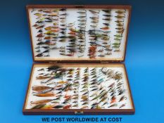 A simple hinged fly box containing salmon and sea trout flies