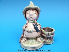 A Pendelfin figure of a boy in a hat by a coopered pot (13cm tall)