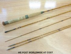 A Hardy three piece split cane fishing rod with two spare top crops and in original cloth bag
