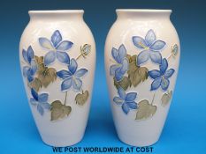 A pair of Moorcroft vases decorated with blue hepaticas on a cream ground (19cm tall)
