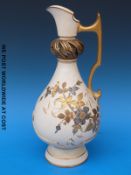A Royal Worcester ivory ground ewer with applied gilded floral decoration and openwork neck (33cm