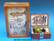 A hinged wooden three tier four compartment fly box full of trout flies and a fishing display box