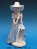 A Nao figurine of a girl in a sunhat (27cm tall)