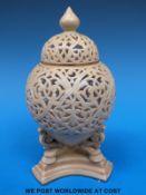 A Royal Worcester lidded ivory pot pourri on tripod legs,