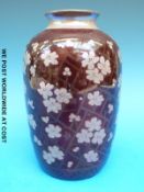 A Pilkington's Lancastrian shouldered vase hand decorated with flowers on a burgundy ground,