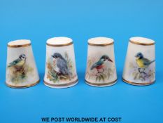 Four Royal Worcester thimbles hand decorated with birds,