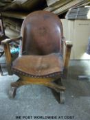 An Art Deco leather chair with embossed armorial crest