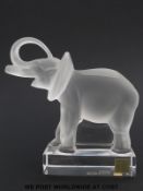 Lalique glass model of an elephant with trunk aloft, on plinth,