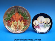 A Moorcroft pin dish c2005 with a three-candle design (12cm diameter) and a Moorcroft plate c1997,