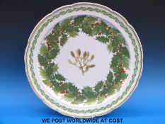 A very large Copeland charger decorated with holly and mistletoe and edged with gilt,