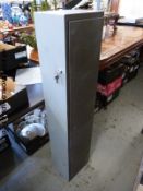 A metal gun cabinet with keys