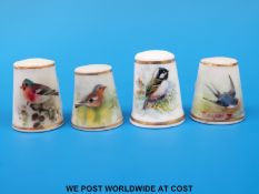 Four Royal Worcester thimbles hand decorated with birds,