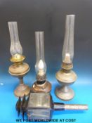 Three brass/copper oil lamps and a coaching lamp